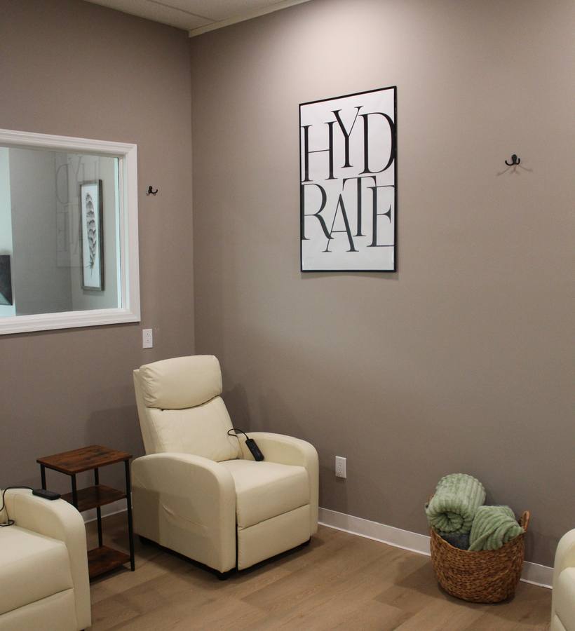 IV therapy room with cream recliners and blankets